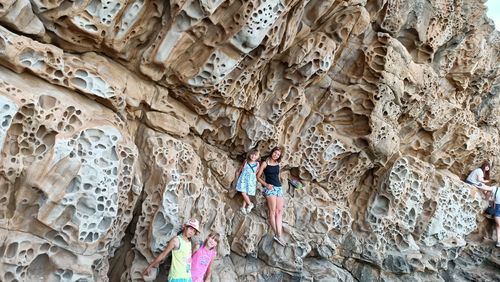 Rear view of people on rock formation