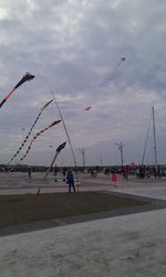 Silhouette of people against cloudy sky