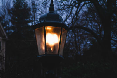 Close-up of illuminated lamp at night