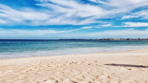 Scenic view of beach against blue sky