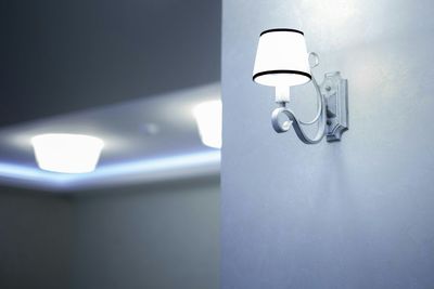 Electric lamp against white wall