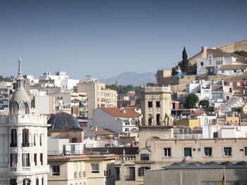 Buildings in city against clear sky