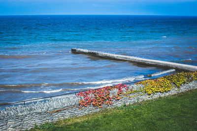 High angle view of beach by sea against sky