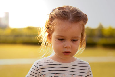 Close-up of cute boy looking away