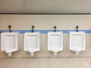 Row of objects on tiled floor