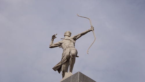 Low angle view of statue against sky