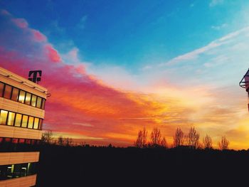 Silhouette buildings against sky during sunset