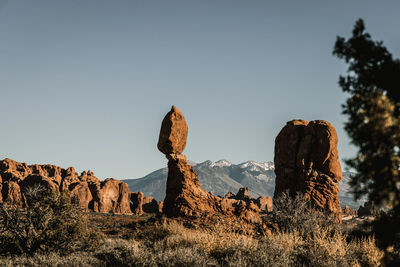 Low angle view of a balancing rock formations against clear sky at arches national park moab utah us