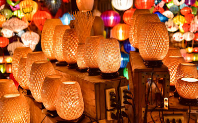 Close-up of illuminated lanterns hanging for sale