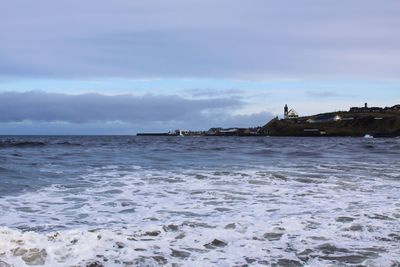 Scenic view of sea against cloudy sky