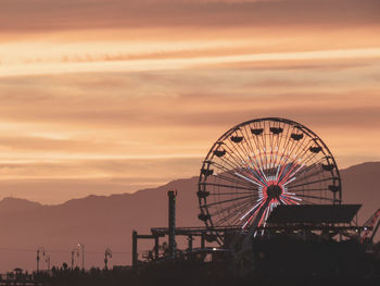 Ferris wheel against sky during sunset