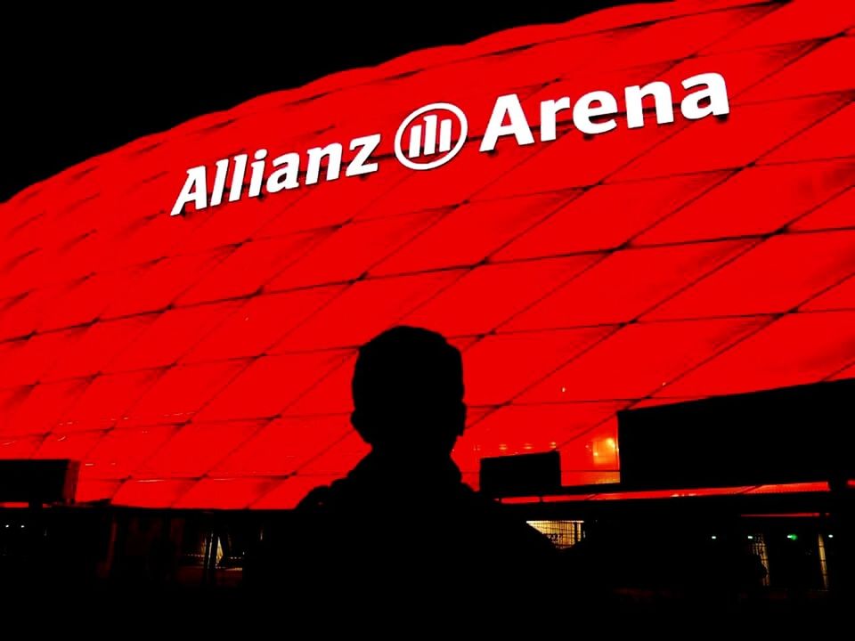 SILHOUETTE OF MAN WITH TEXT AGAINST RED LIGHT