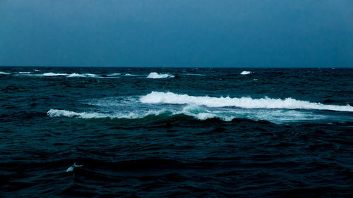 Scenic view of sea against clear blue sky