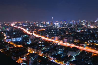 High angle view of illuminated city buildings at night