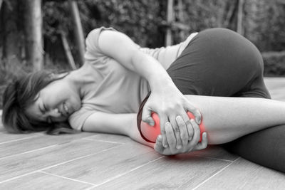 Midsection of woman relaxing on sofa