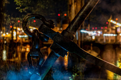 Close-up of metallic equipment outdoors at night