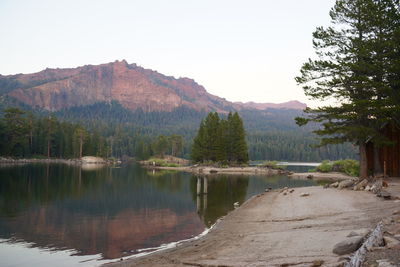 Scenic view of lake and mountains against clear sky