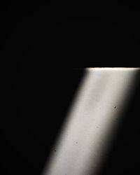 High angle view of sunlight falling on wall in darkroom