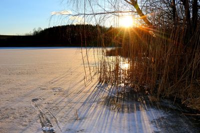 Scenic view of lake against sky during winter