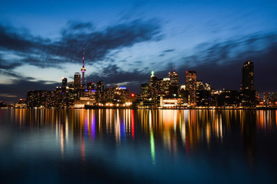 Illuminated buildings against sky at night