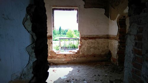 Abandoned building seen through window