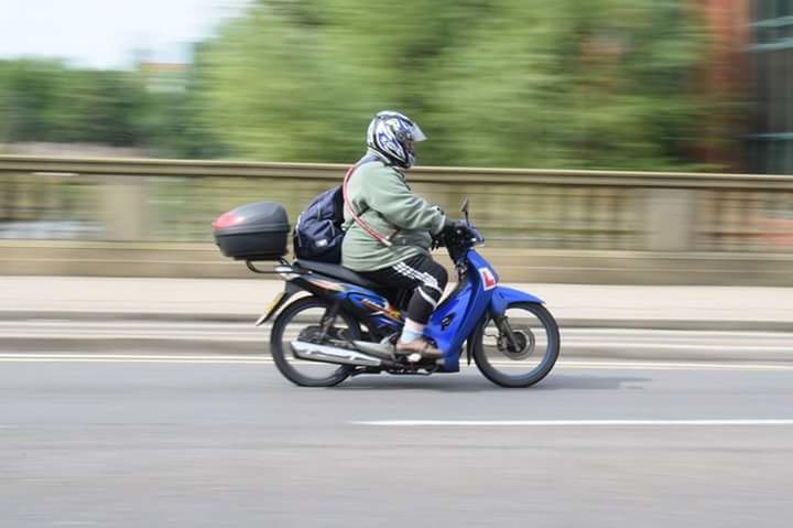 BLURRED MOTION OF MAN RIDING BICYCLE