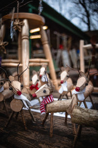 Close-up of stuffed toy hanging on wood