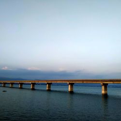 Bridge over sea against sky