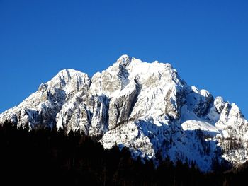 Scenic view of mountains against clear blue sky