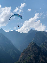 Person paragliding against sky