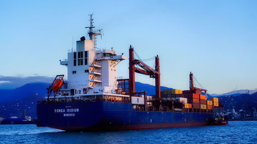 Commercial dock by sea against sky