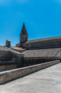 Low angle view of old building against blue sky