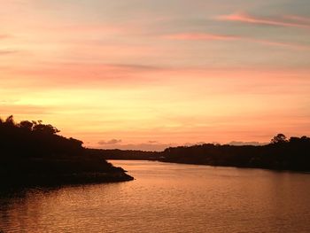 Scenic view of sea against orange sky