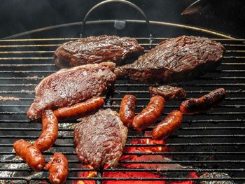 Sausages and meat on barbecue grill