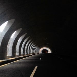 Road in illuminated tunnel