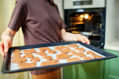 Midsection of man holding jigsaw pieces