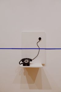 Close-up of vintage telephone against wall