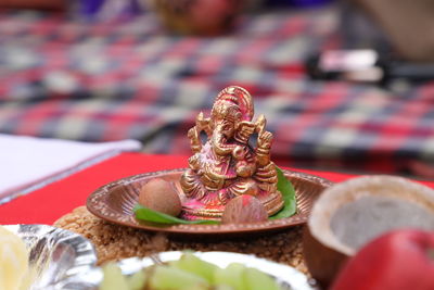 Close-up of ganesha figurine on table