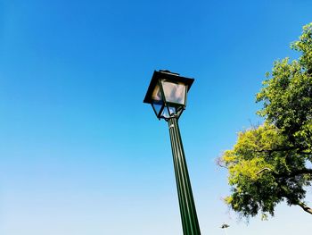 Low angle view of street light against clear blue sky