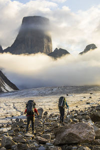 Two climbers en route to climb mount asgard, baffin island.