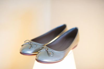 Close-up of shoes on table against white background