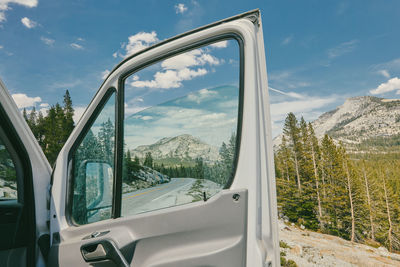 Open camper van door on highway in yosemite national park.