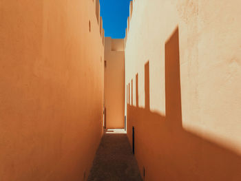 Traditional architecture in light and shadows. empty old alley amidst buildings