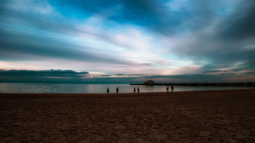 Scenic view of beach against sky during sunset