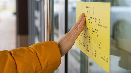 Cropped hand of person holding paper