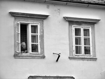 Window of old building with an elder woman