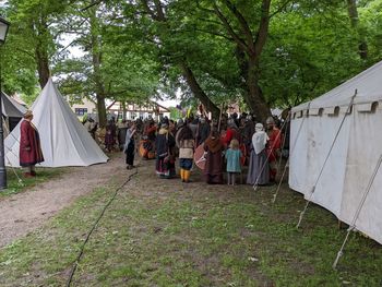 Low section of people walking on field