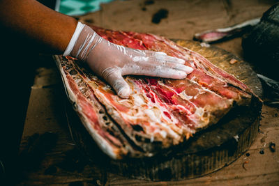 Cropped hand of person preparing food