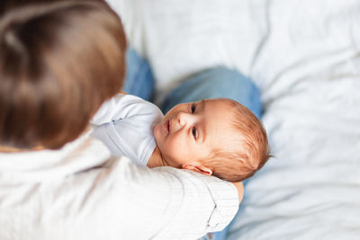 Woman holding her child. mother comforts her little son or daughter.