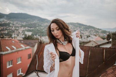Woman wearing lingerie while standing in city